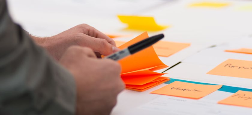 Close up of person using notes to help understand brand definition